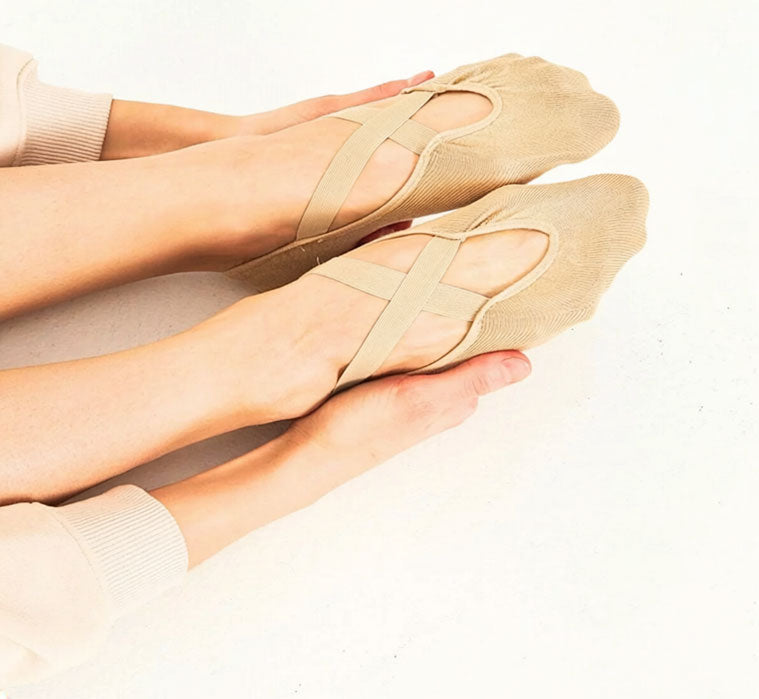 Model wearing nude ballet grip socks with criss-cross straps