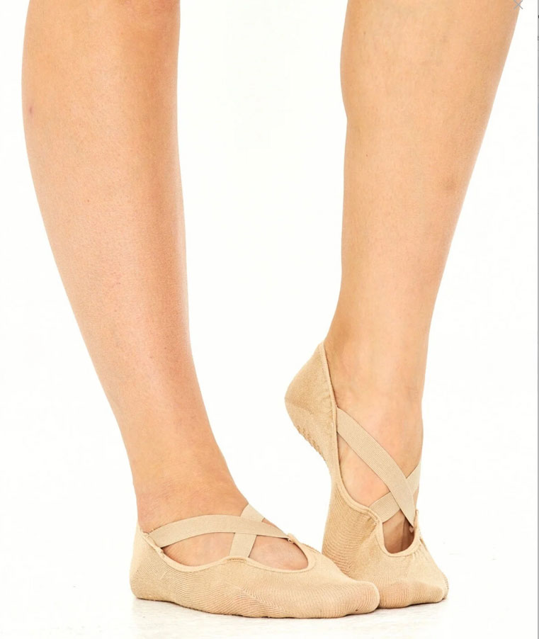 Nude ballet grip socks worn standing on tiptoe