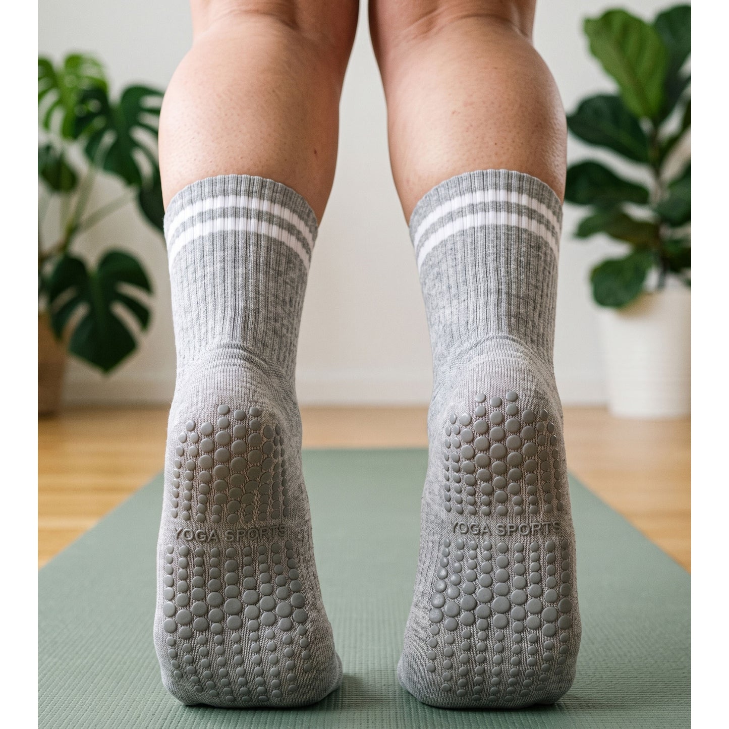 Back view of grey crew grip socks with grip soles on a yoga mat