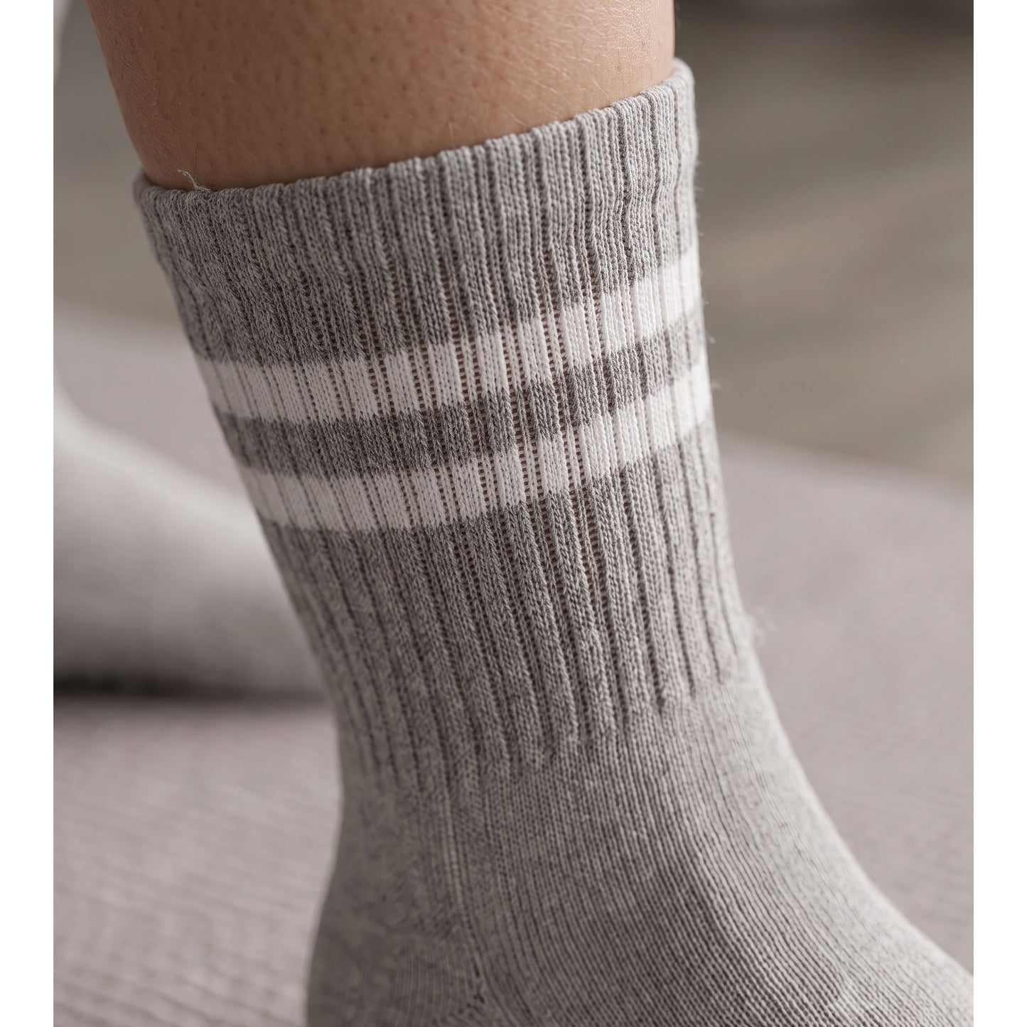 Close-up of grey ribbed crew cuff with double white stripe