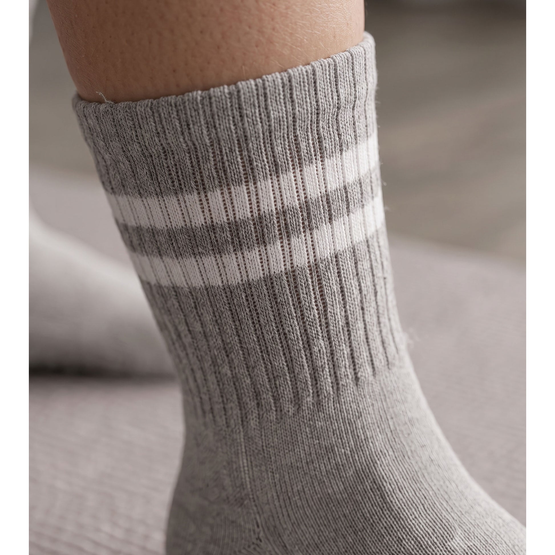 Close-up of grey ribbed crew cuff with double white stripe