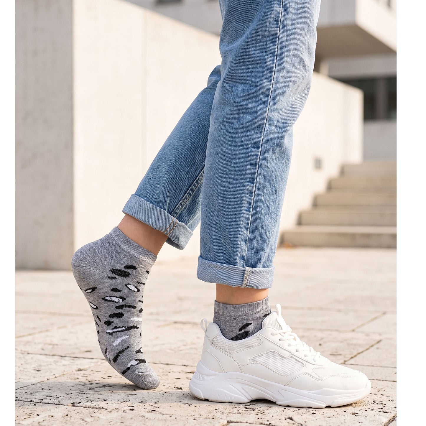 Grey leopard sneaker socks worn with white trainers