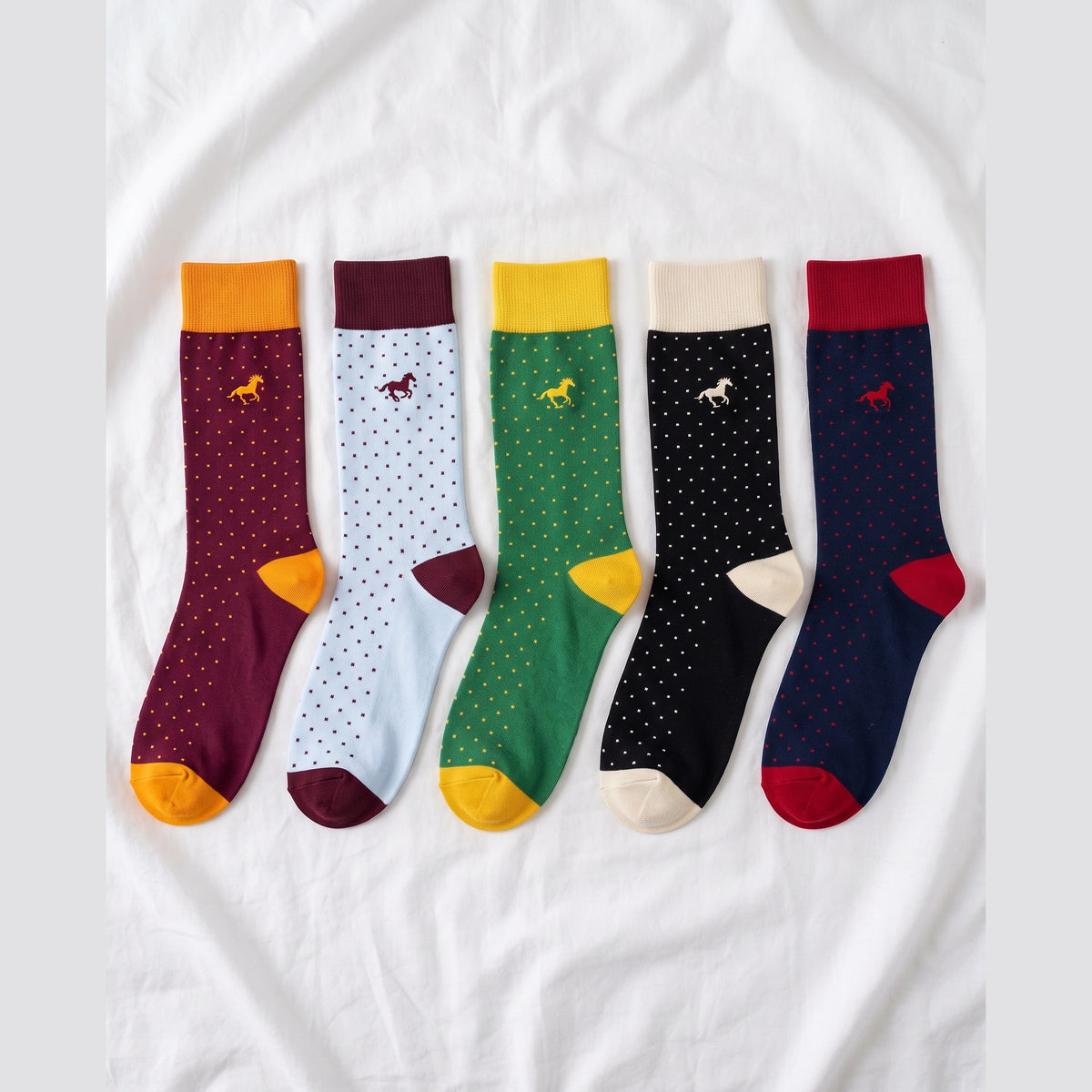 Louluu Galloper Pin Dot crew socks with contrast cuffs in burgundy, ice blue, green, black and navy — flat lay