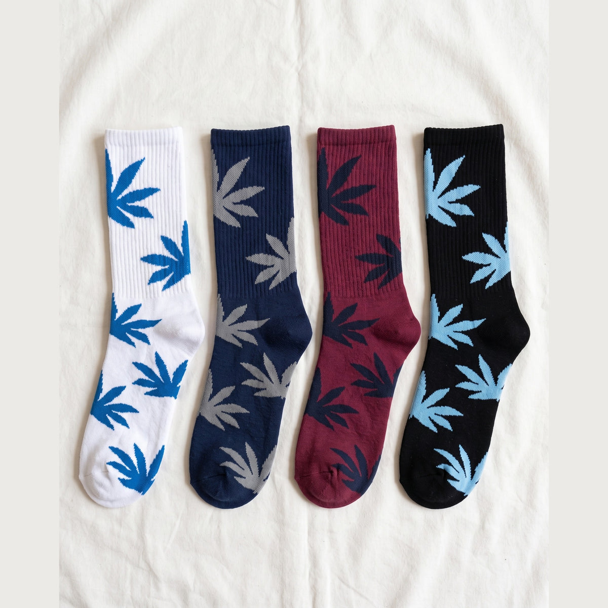 Louluu Leaf cushioned cotton crew socks in white, navy, burgundy and black with contrast leaf motifs — flat lay