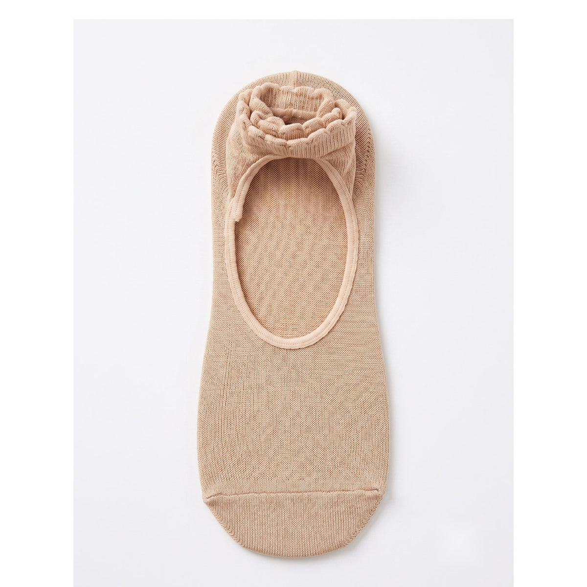 Nude pilates grip sock — open instep window and scalloped ribbed cuff, top view